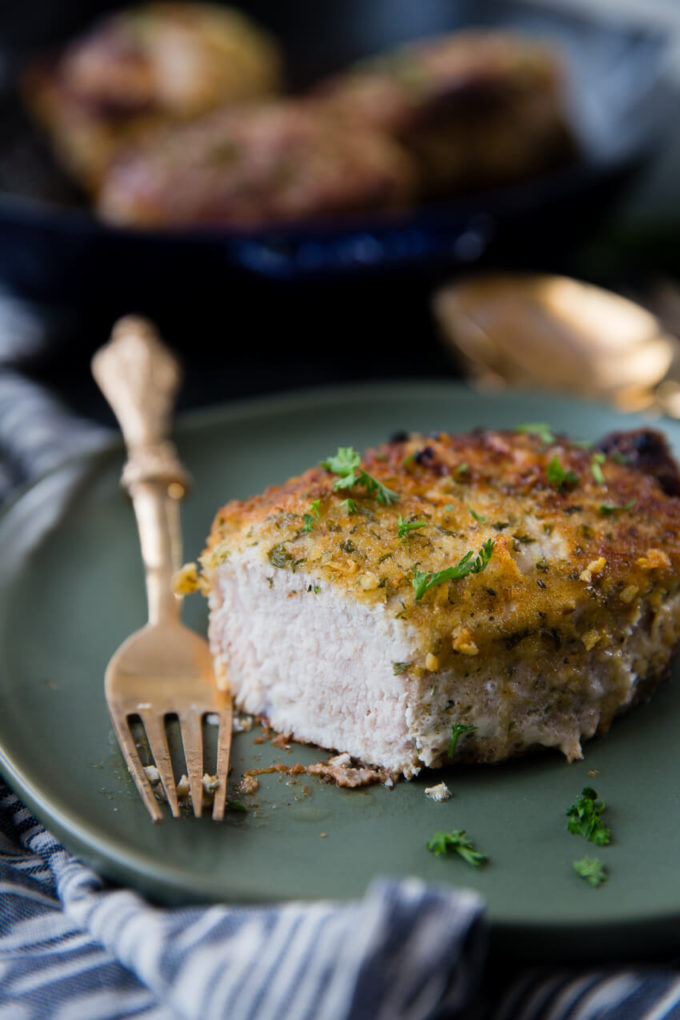 Oven baked pork chops that are breaded in Italian breadcrumbs and parmesan