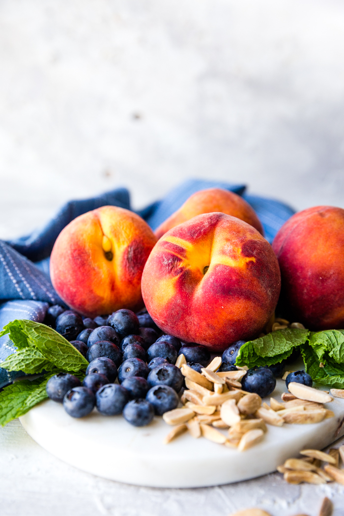 Peaches, blueberries and nuts on a plate