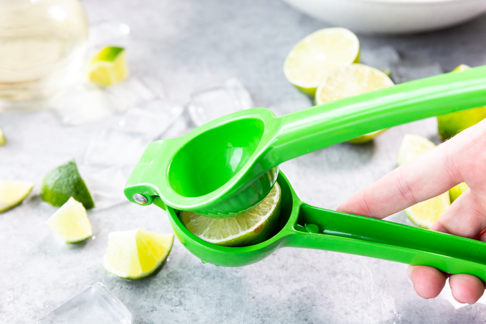 A citrus juicer with a lime in it