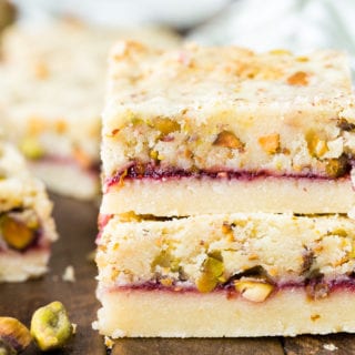 Two raspberry pistachio shortbread bars