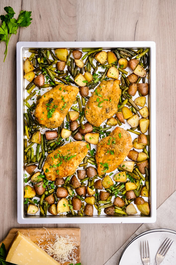 Sheet Pan Parmesan Chicken and Veggies: A single sheet pan is all it takes to bake this sheet pan parmesan chicken and veggie spread!