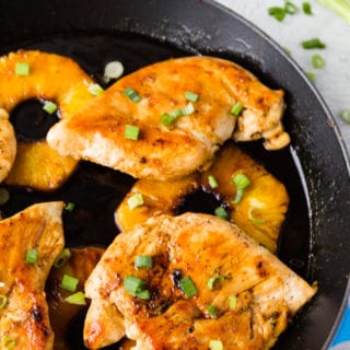 Skillet teriyaki chicken, laying on top of pineapple rings.