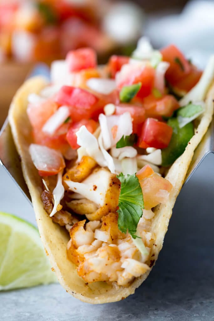 Tilapia Fish Tacos: Easy to make, mildly flavored, delicious, flaky, and loaded with flavor. These tilapia fish tacos are healthy, easy, and delicious.