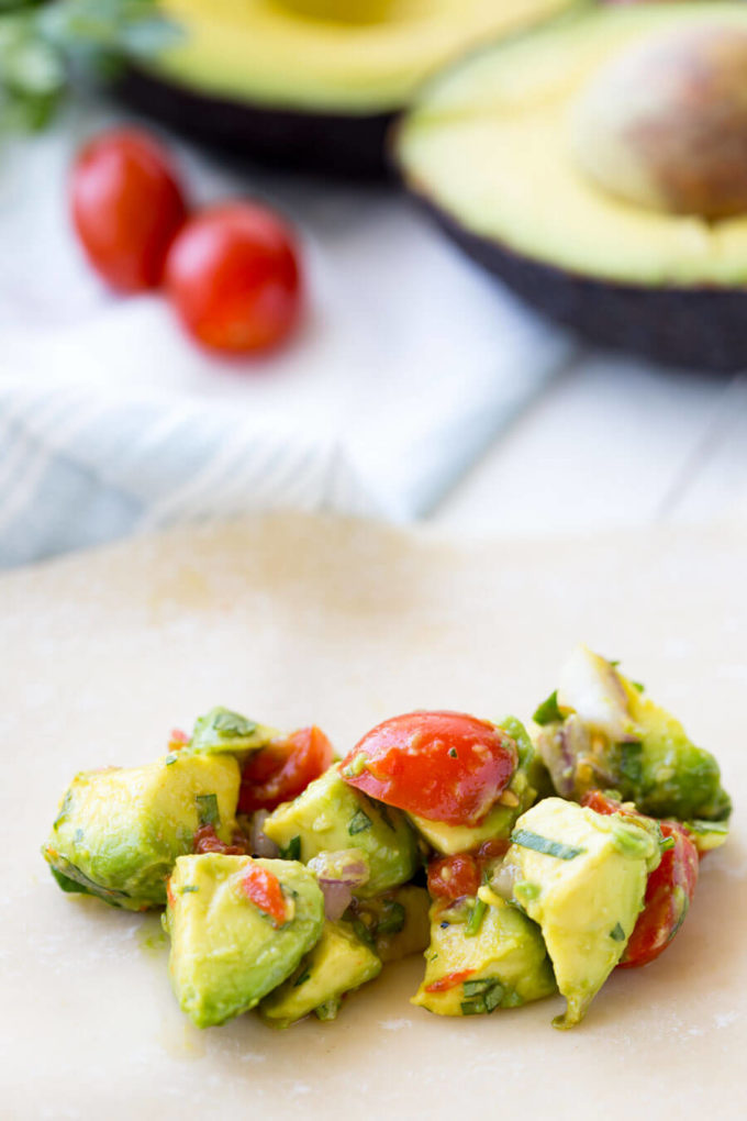 Avocado Egg Rolls: Crunchy egg roll wrapper filled with chunks of California Avocados, cilantro, tomatoes, red onion, and roasted red peppers; dipped in a creamy avocado ranch dipping sauce!