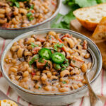 Black Eyed Beas in a grey bowl with spoon. to the side