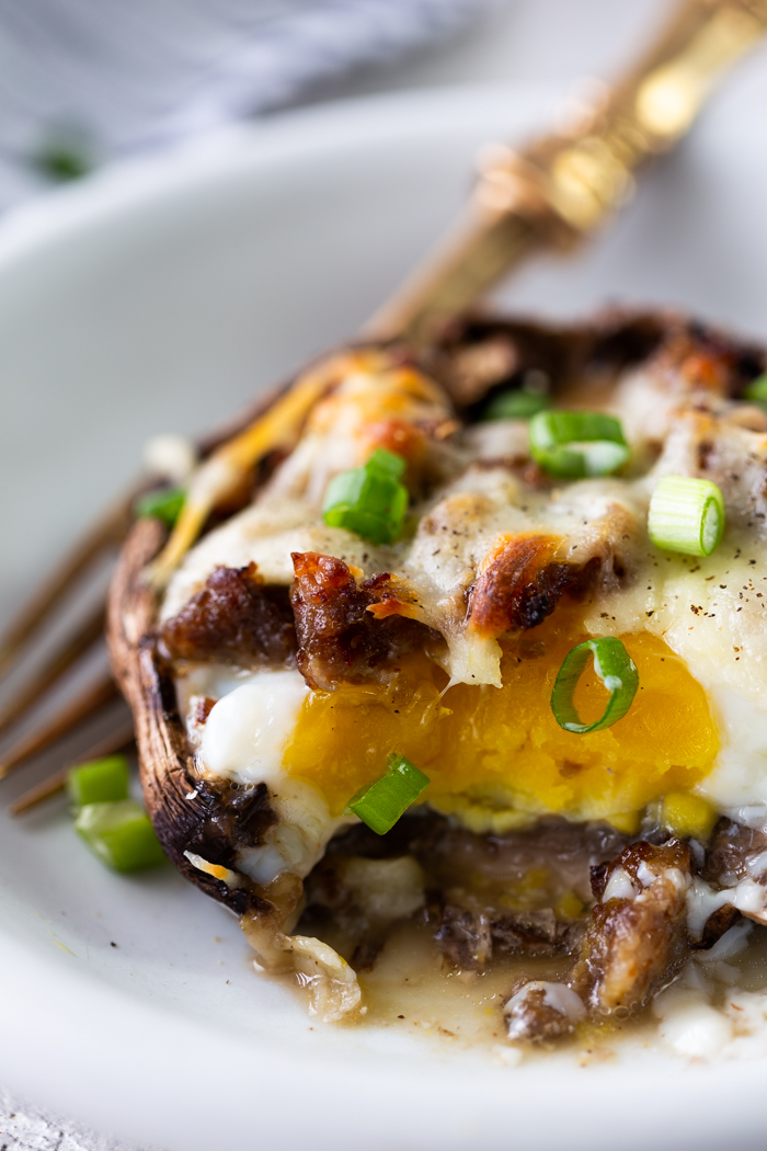 A white plate with a breakfast portobello mushroom on top