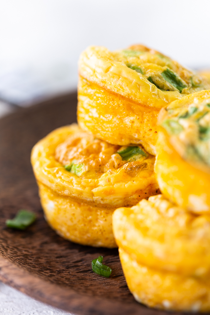 Close up of 4 buffalo chicken egg muffins on a brown plate 