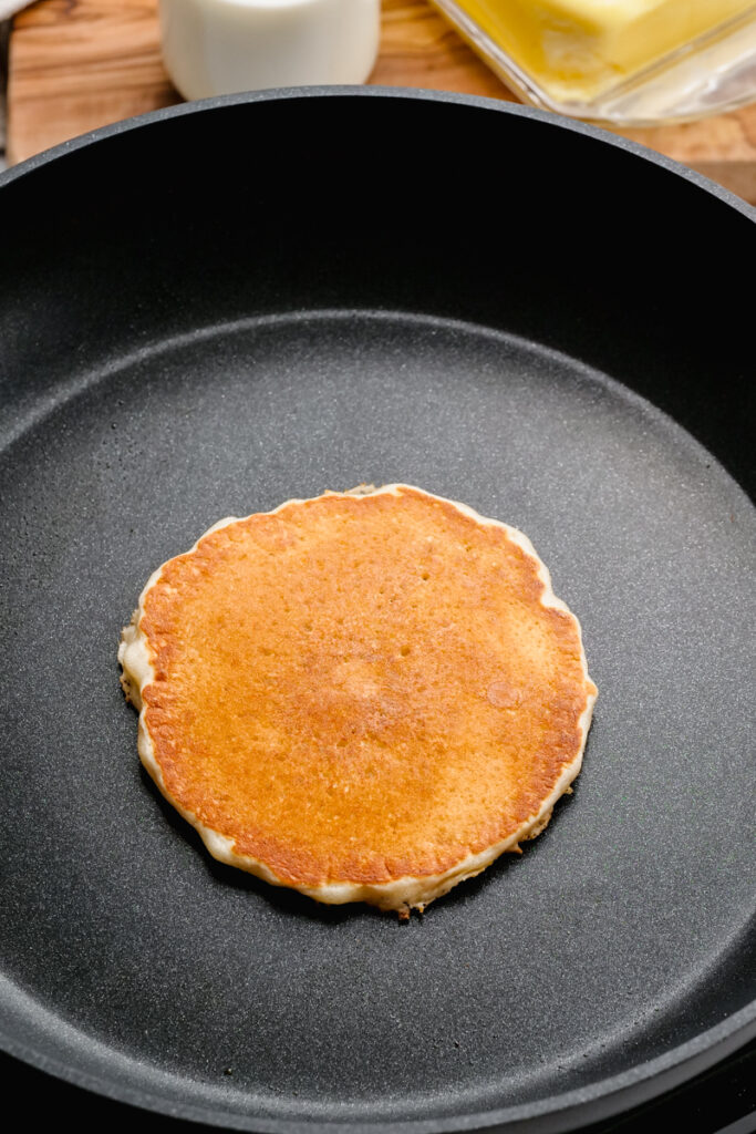 Flipped buttermilk pancake that is golden brown