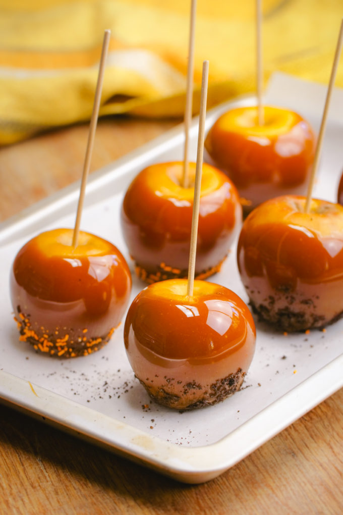 Making the best caramel apples, 5 apples on a tray. 