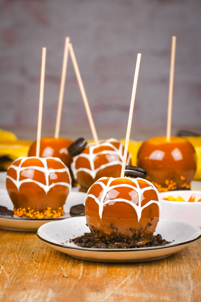 A plate with a Halloween decorated caramel apple