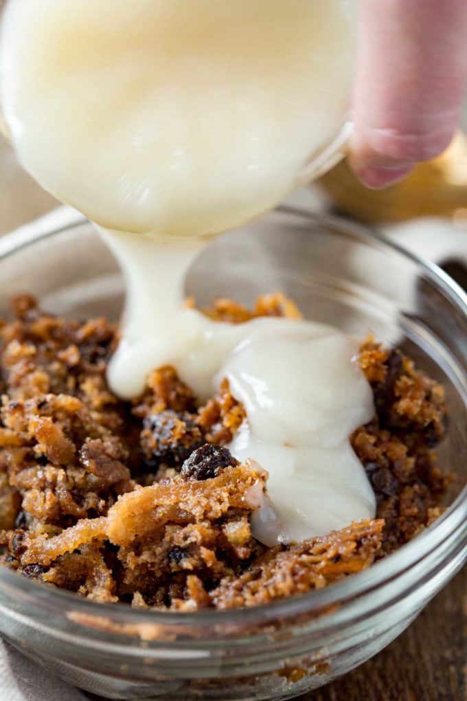 Pouring sauce over the carrot pudding