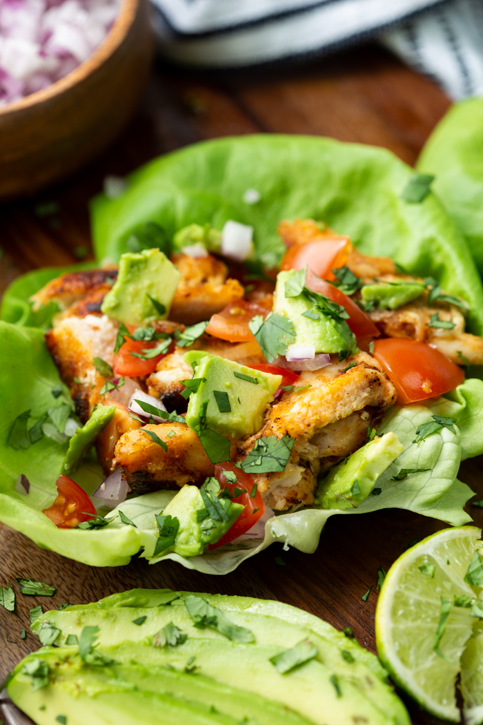 Chicken taco lettuce wraps on a cutting baord