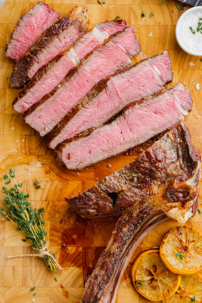 Classic ribeye sliced and served on a cutting board