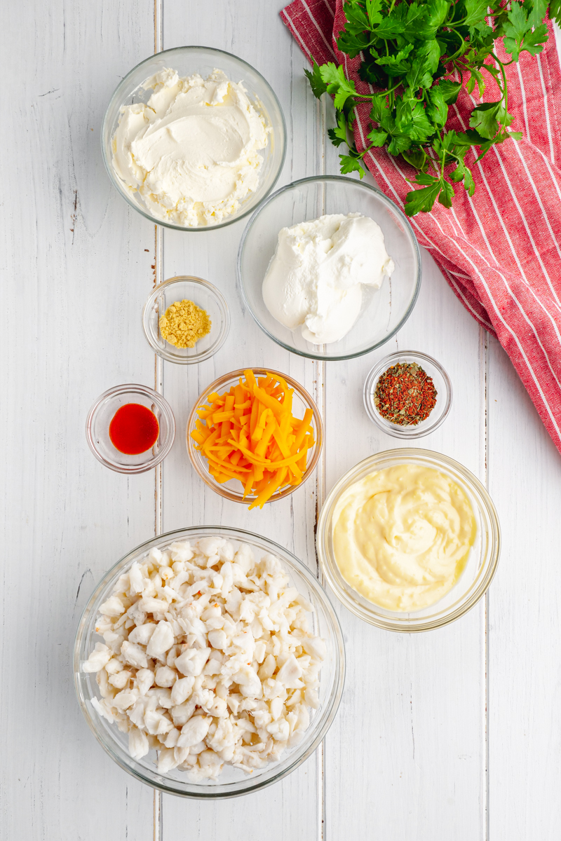 All the ingredients for crab dip in small glass bowls