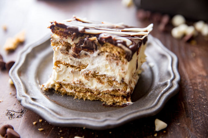Simple Eclair Ice Box Cake: No baking, no fuss, this easy ice box cake is absolutely delicious and just so fun. Rich chocolate topping, fun vanilla custardy center, and graham crackers. It tastes like an eclair in cake form! And is way easier than baking eclairs.