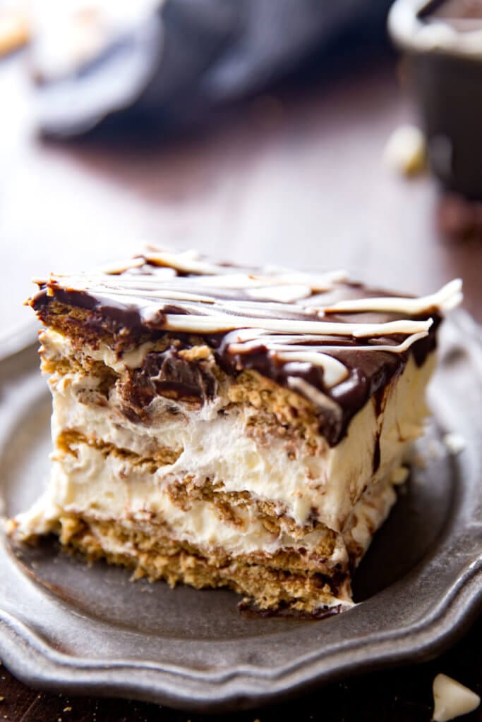 Simple Eclair Ice Box Cake: No baking, no fuss, this easy ice box cake is absolutely delicious and just so fun. Rich chocolate topping, fun vanilla custardy center, and graham crackers. It tastes like an eclair in cake form! And is way easier than baking eclairs.