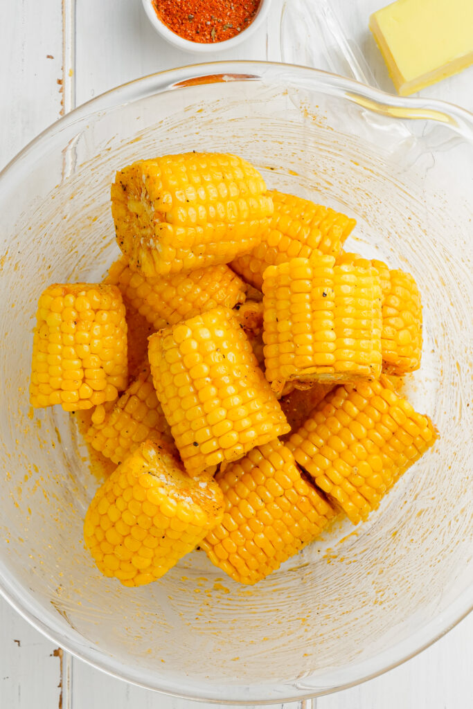 Roasted Halibut Sheet Pan Dinner with corn in a clear glass bowl.
