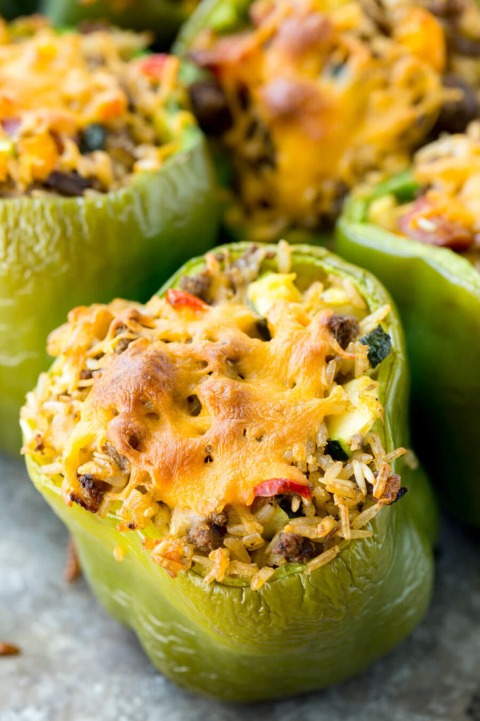 A green bell pepper stuffed with rice, sausage and veggies topped with crisp cheese