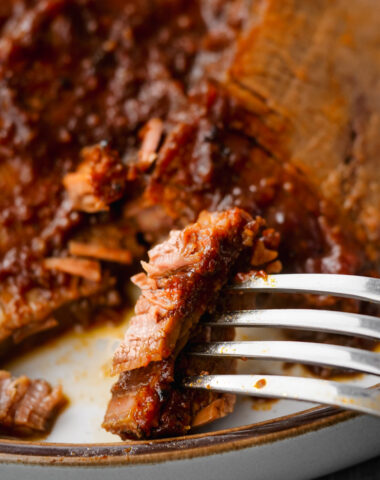 instant pot brisket on plate with fork to the side