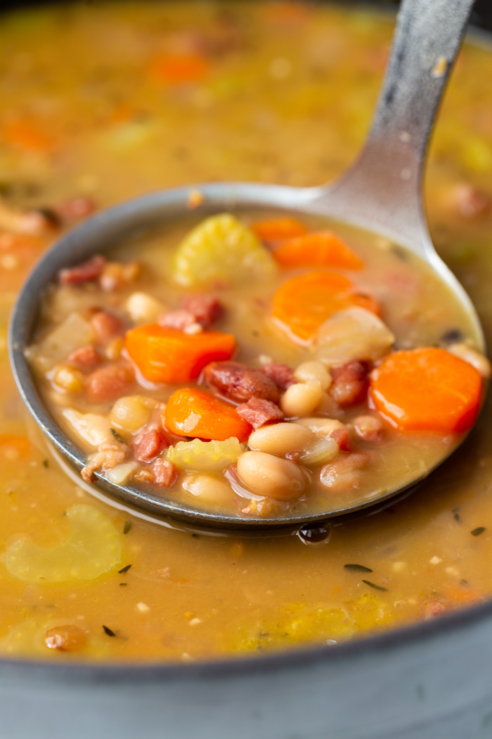 close up of instant pot ham and bean soup in a latle