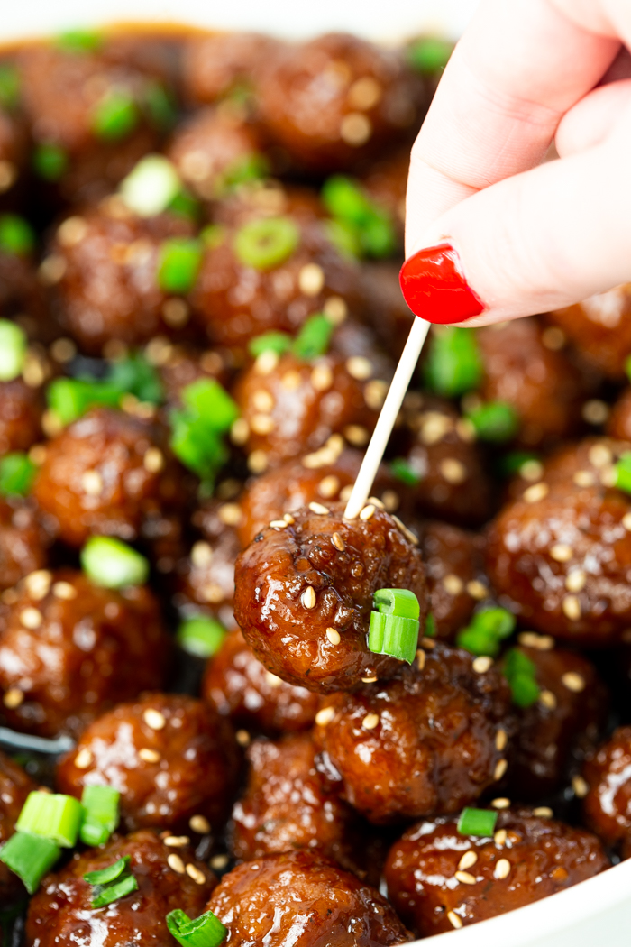 mongolian beef meatball with a toothpick being inserted