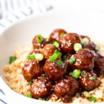 Mongolian beef meatballs in a white bowl on a bed of rice