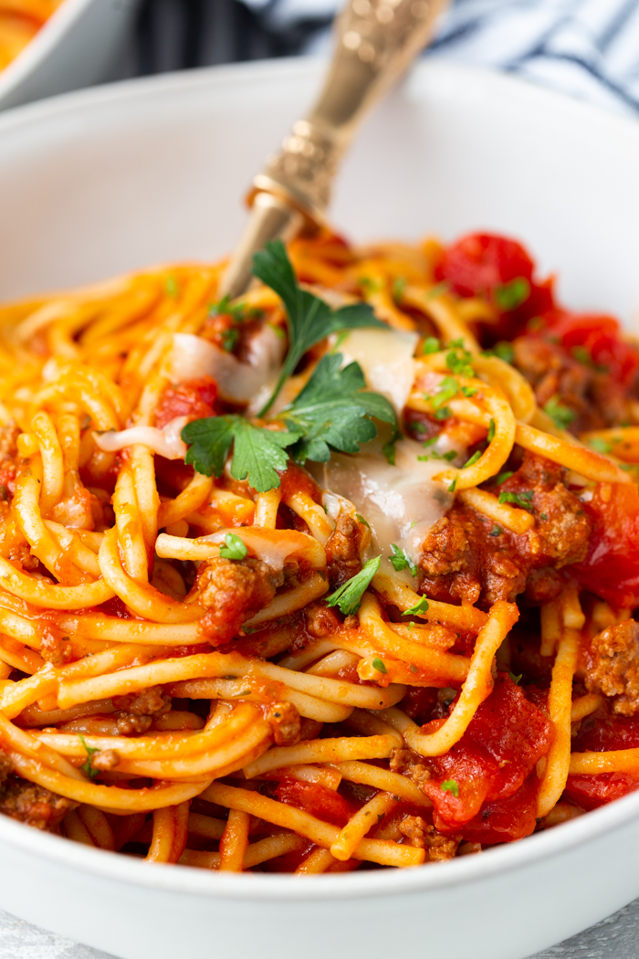 instant pot spaghetti with meat sauce in a bowl with a fork.