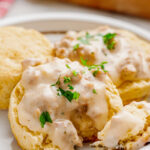 A white plate covered in biscuits and gravy