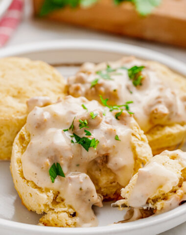 A white plate covered in biscuits and gravy