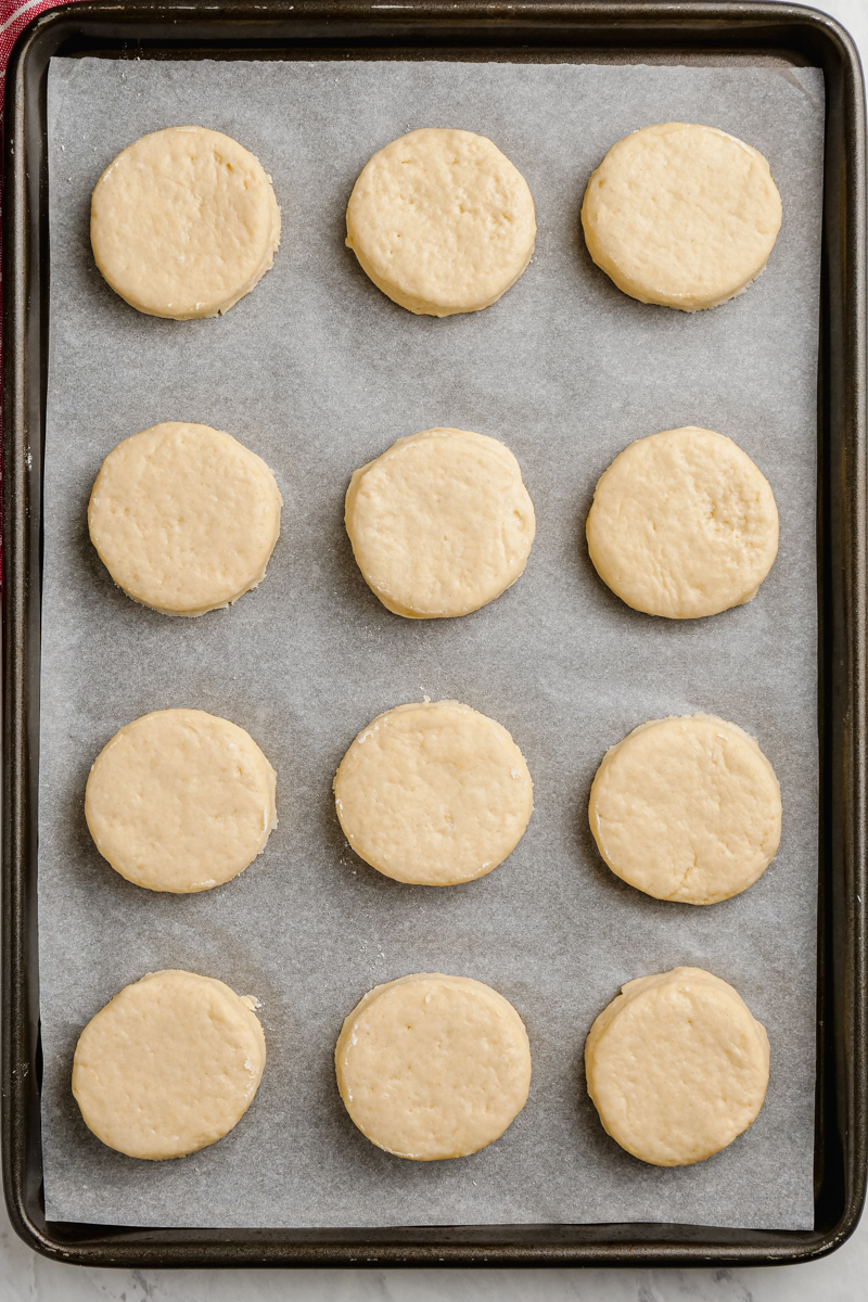 Biscuits rolled out, cut and put onto a pan for baking