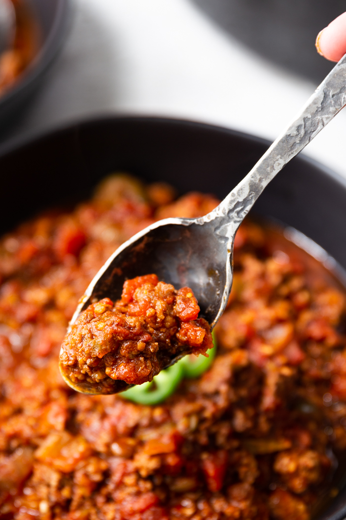 a bowl and spoonful of chili 