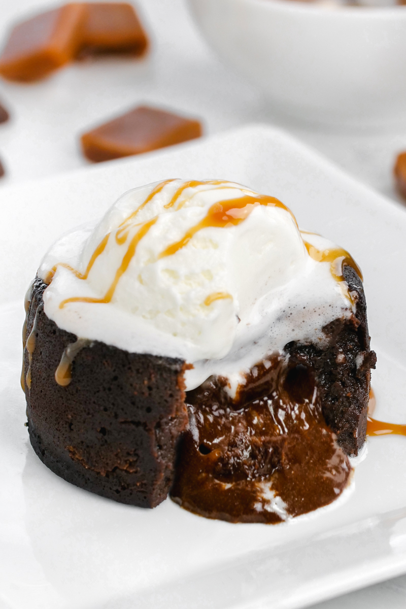 Caramel center is oozing out of the instant pot lava cake, chocolate molten lava cake with caramel center and topped with ice cream