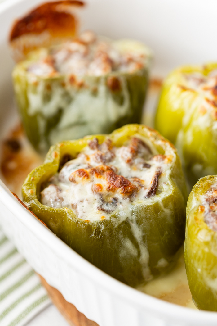 a casserole dish with philly cheese steak stuffed peppers