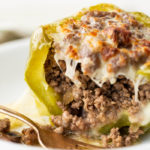 Philly cheese steak stuffed peppers on a white plate