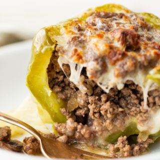 Philly cheese steak stuffed peppers on a white plate