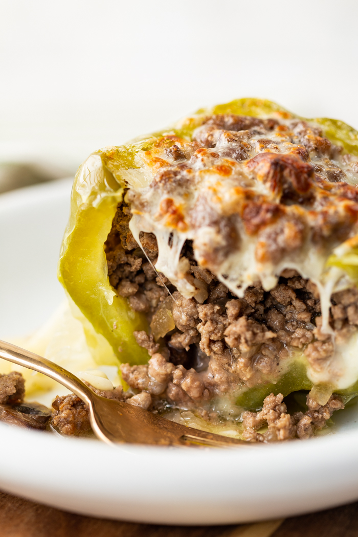 Philly cheese steak stuffed peppers on a white plate