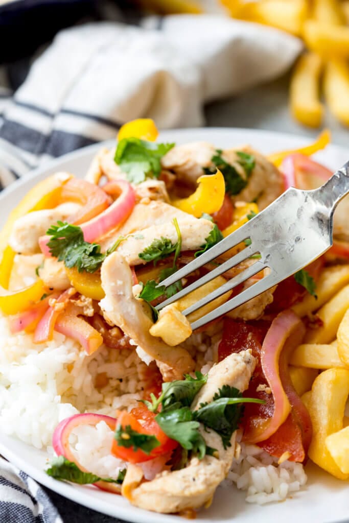 Pollo Saltado a Peruvian chicken stir fry that is served with fries and rice. 