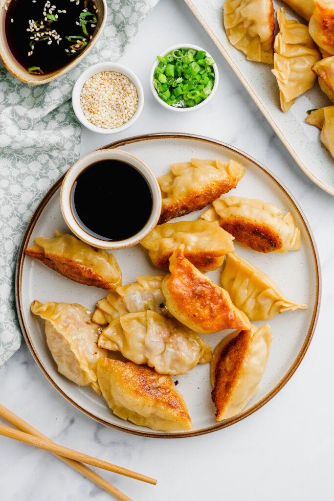 potstickers on plate with dipping sauce