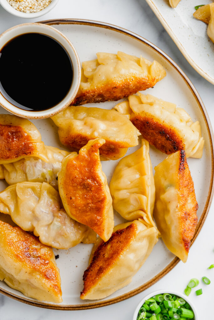 A plate full of pork potstickers, and crunchy exterior, delicious interior. 