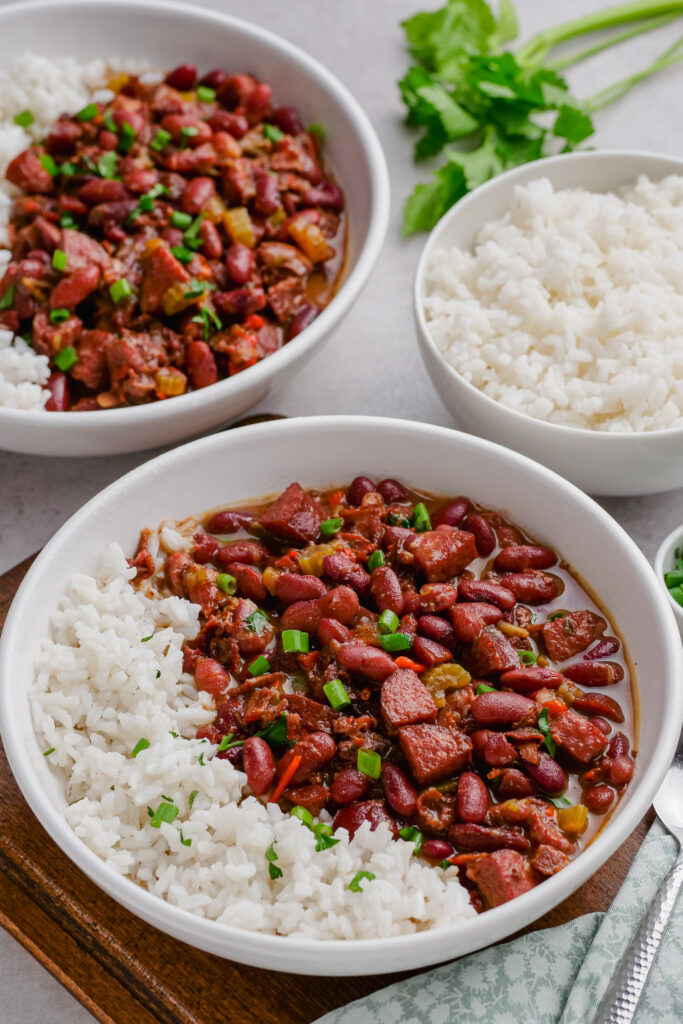 red beans and rice in two white serving bowls