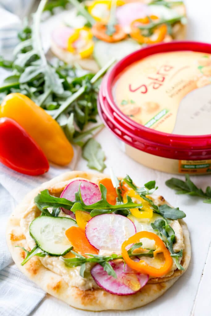 Vegetable Hummus Flatbread is flatbread slathered in hummus and topped with mandolin sliced veggies