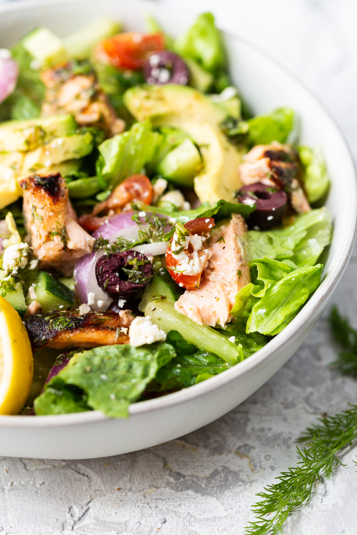 A bowl full of salmon avocado salad