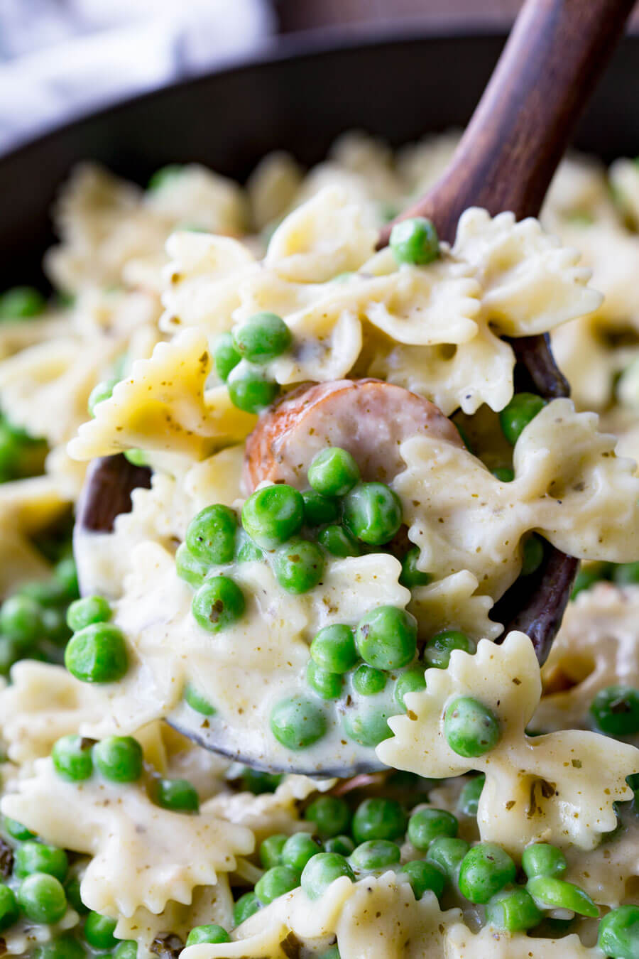Quick, easy, and oh so delicious, this skillet pasta is a real winner with chicken sausage, peas, alfredo, and pesto