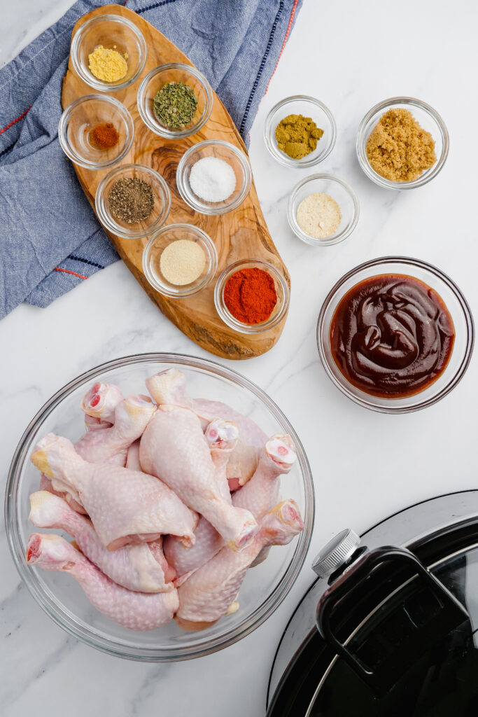 Slow Cooker BBQ Drumsticks ingredients in bowls on a table.