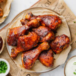 Slow Cooker BBQ Drumsticks on a plate with sauces to the side