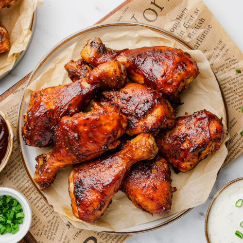 Slow Cooker BBQ Drumsticks on a plate with sauces to the side