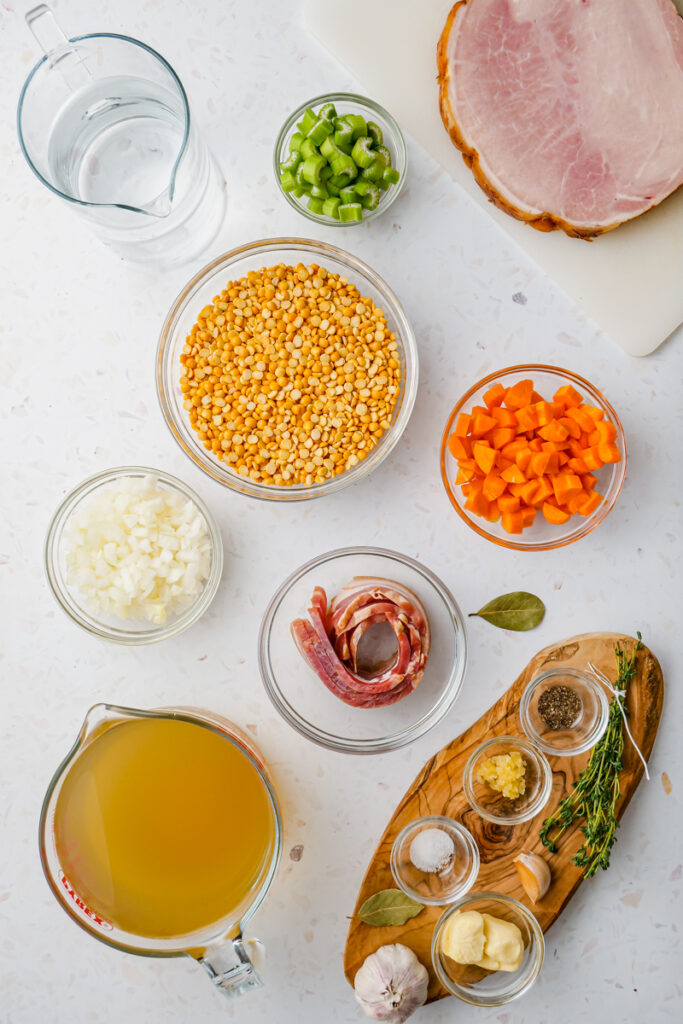 ingredient for split pea soup on counter in glass bowls