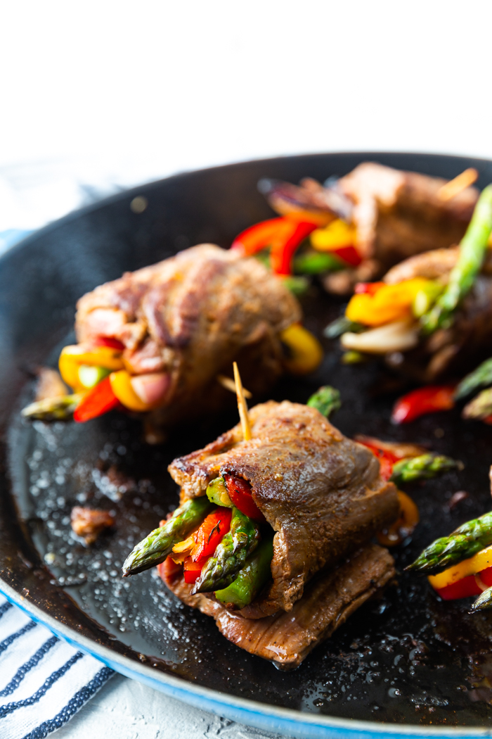 Steak roll up in a hot cast iron pan. Steak fajitas