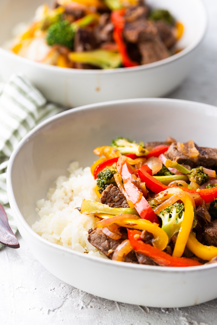 steak stir fry with most of the second bowl in background