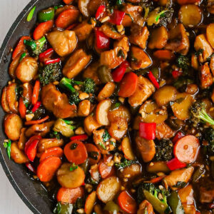 A wok full of stir fried chicken and vegetables